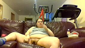 Chubby girl pisses pants while glued to TV screen