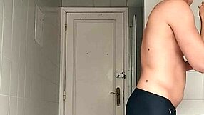 a sexy guy slips into the bathroom at the beach pulls down his black shorts and carefully shaves his smooth body