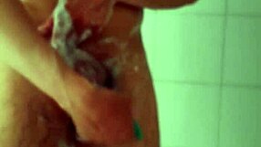 Big dick male carefully shaves his penis in the bathroom