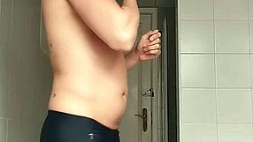 a sexy guy slips into the bathroom at the beach pulls down his black shorts and carefully shaves his smooth body