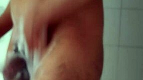 Big dick male carefully shaves his penis in the bathroom