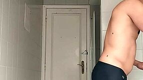 a sexy guy slips into the bathroom at the beach pulls down his black shorts and carefully shaves his smooth body