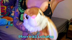 tattooed girl bathes easter bunny plushie wet in bed