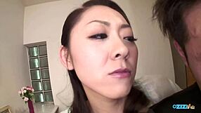 enchanting Asian mistress grinds puffy pussy on toy held in his mouth