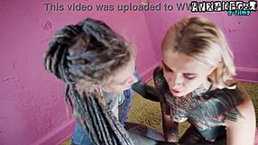 tattooed goth lovers sharing wild strap-on fun with piercings and toys