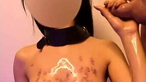 Submissive redhead trembles in ecstasy as master drips hot wax over her bound body