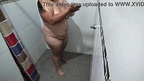 i put a hidden camera in my stepmoms bathroom and record her taking a shower and touching her tits and her pussy very rich homemade real delight