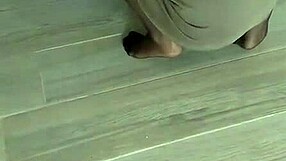 turbaned mature woman in nylon stockings wipes the floors carefully